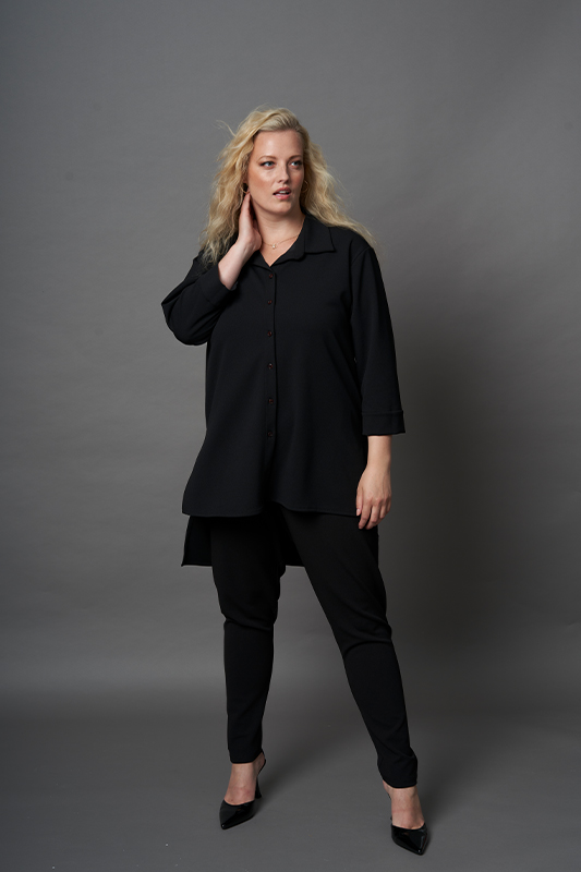 A black or red plus size Cuffed Long Sleeve High Low Hem button top with a tabbed collar, made of scuba crepe fabric from One SIx.